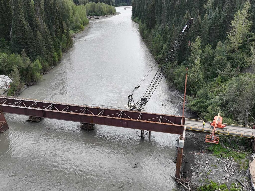 Crane Erecting Steel for the Bell Irving Bridge Project in the River